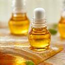 Close-up of nourishing botanical oils like jojoba and argan, with soft natural light.