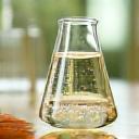 Bubbling fermentation jars with natural ingredients, representing probiotic skincare.